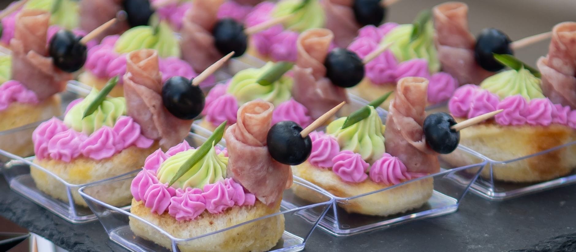 Canapés arranged in clear disposable cups